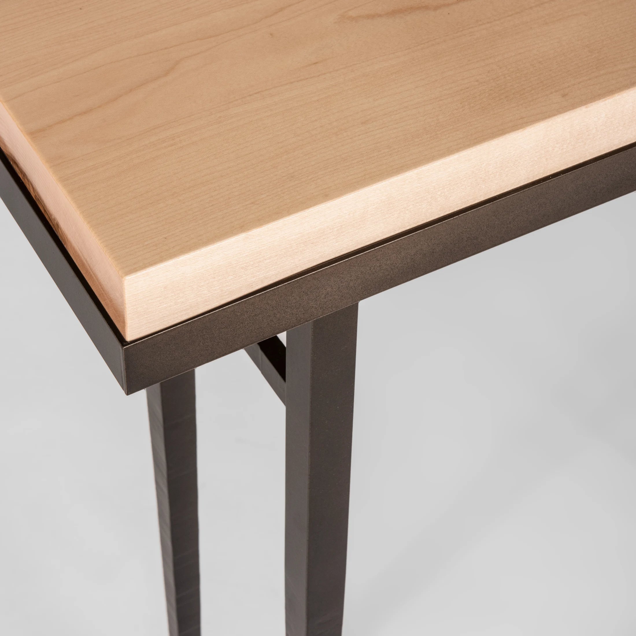 The smallest console table in the Wick Collection, the Wick 30" Console features a 1.5" thick, solid Vermont maple wood top. The maple wood top fits securely, filling the console's narrow steel frame from edge-to-edge.