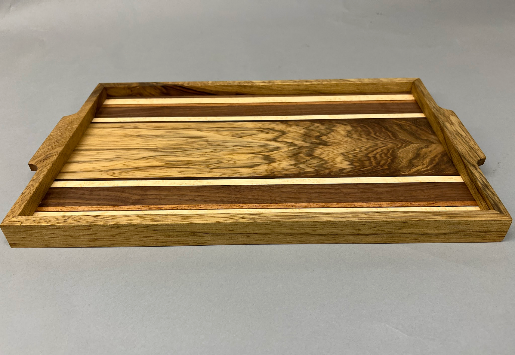 Black Limba, Maple, Walnut, Sapele tray with handles. Finished in Tung oil - naturally water resistant.