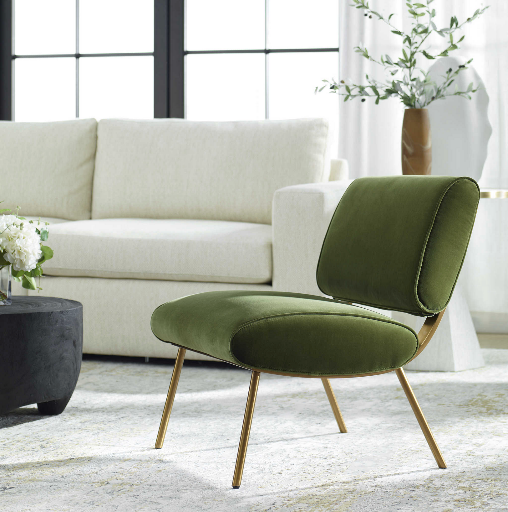 Bold mid-century style is elevated with the dramatic back of the Knoll Accent Chair. Crafted from stainless steel in brushed brass with button accents. Upholstered in a smooth olive green polyester velvet. Fabric is 100% polyester.