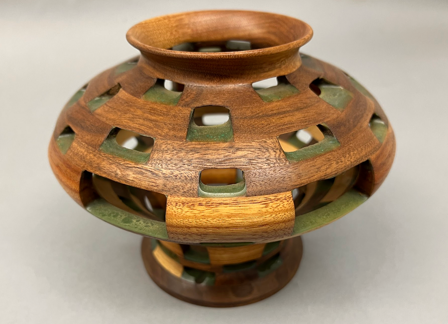 Vase built with Walnut, Canarywood, Maple woods, bound with turquiose.