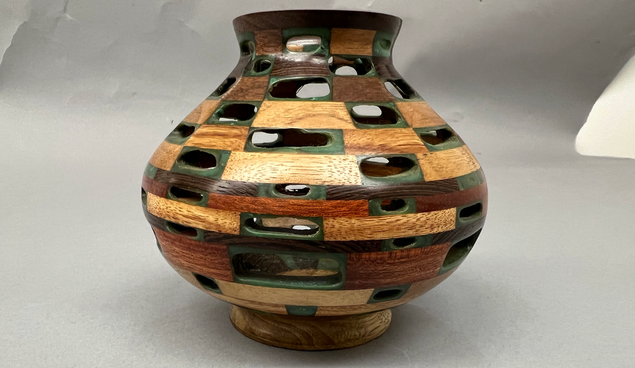 Vase built with Sapele, Bloodwood, Wenge, Black Limba and Canarywood, bound with turquiose.