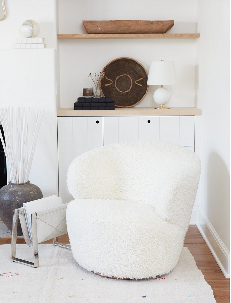 The Myra Chair's soft bouclé faux wool seat and modern, curved form are both cozy and glamorous. She's even complete with a swivel for an easy conversation about the room.